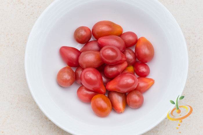 Red Pear Tomato Seeds | Red Pear Tomato fruits in white bowl showing small, ripe, pear-shaped red tomatoes.