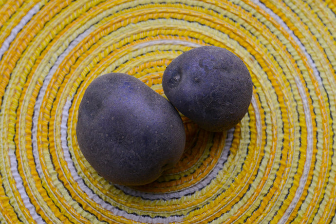 Organic Purple Majesty potato seed round from SeedsNow-Potatoes, showcasing vibrant purple skin and fresh, healthy appearance.